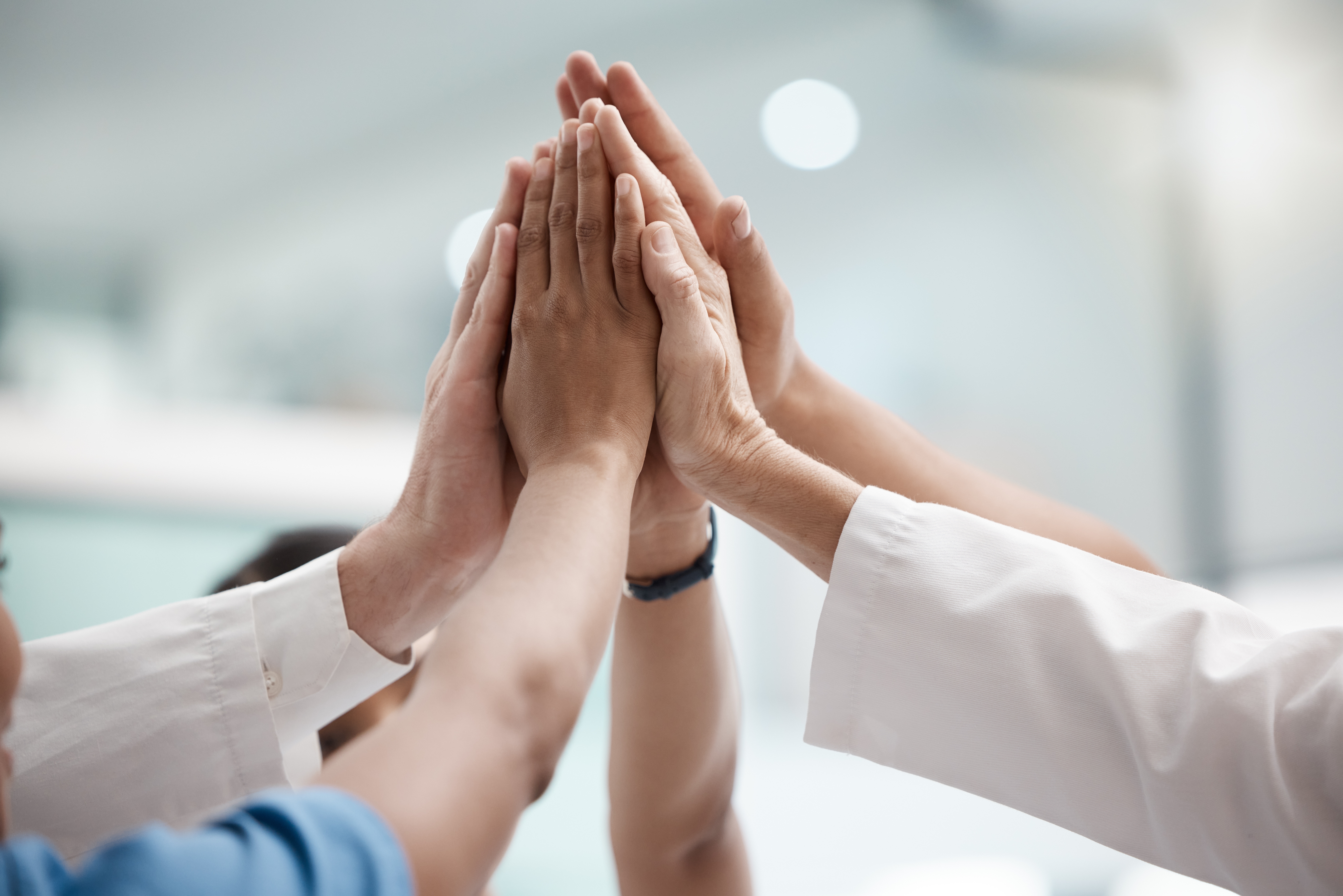 High,Five,,Teamwork,And,Doctors,Hands,In,Collaboration,For,Mission,